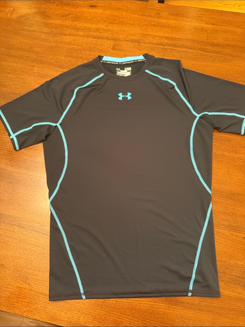 Under Armour Men’s Black Rash Guard with Teal Accents